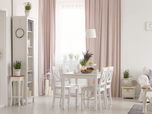 Living room with day curtains letting soft light in. Pink dimout curtains gives the room a modern look.