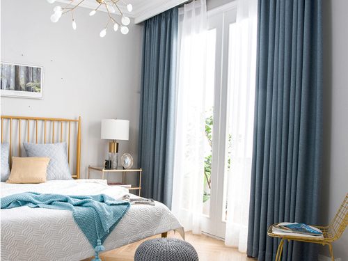 Modern bedroom with day curtains drawn to filter out harsh sunlight. Lets light in with a cool ambience.