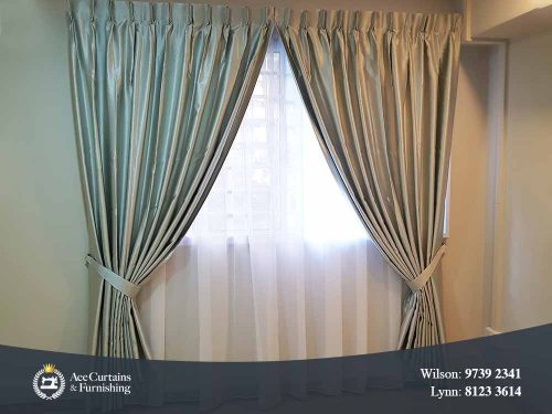 Silver satin shiny night curtains and soft day curtains installed in a bedroom.