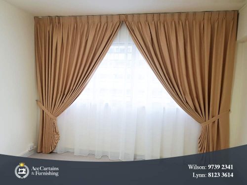 Beige bedroom day and night curtains that are held back with a tie-belt.