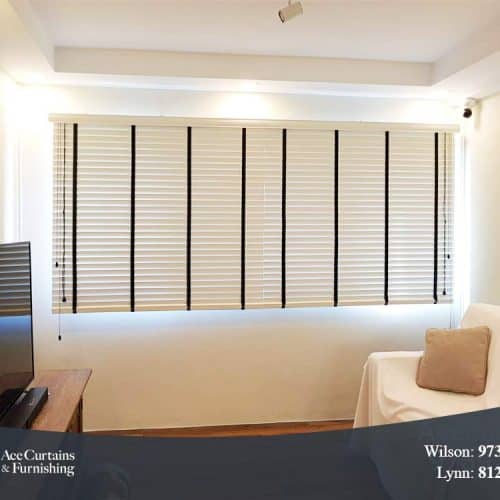 White venetian blind in a small, minimalist living room.