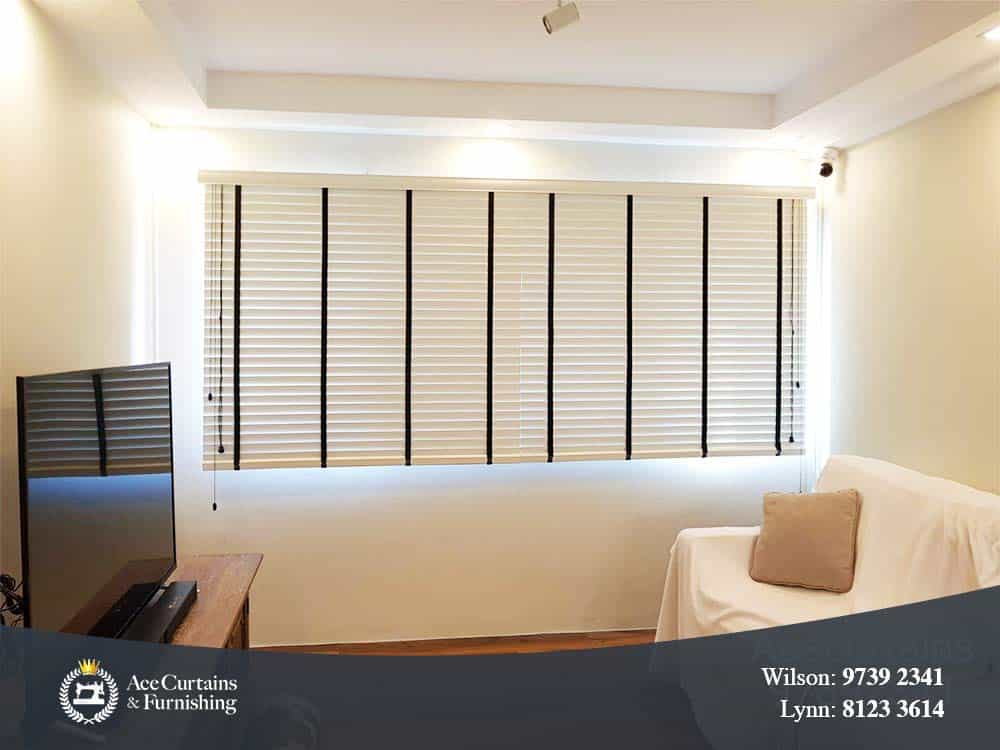 White venetian blind in a small, minimalist living room.