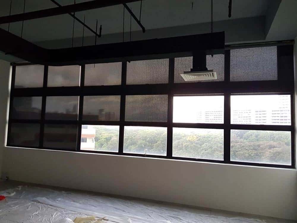 Black roller blinds for commercial shade acting as window shade.