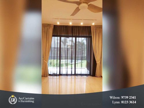 Long floor drop black day curtain and dimout curtain in a living room.