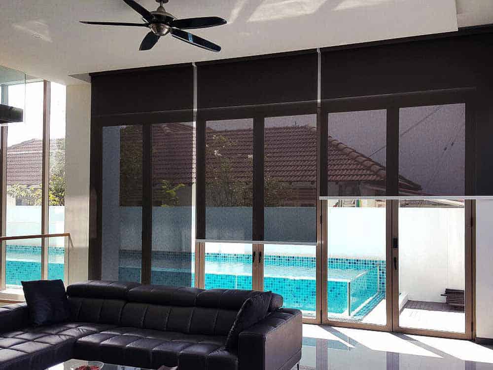 Black roller blind sunshade in a private home with swimming pool