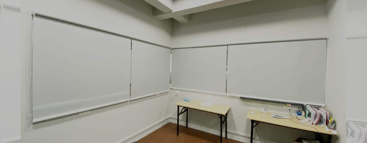 white blackout roller blinds in an office